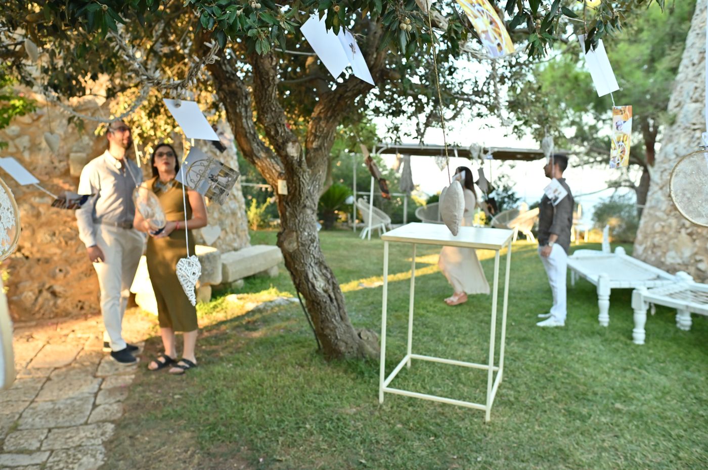 The ceremony area with its floral arch and red carpet above the sea