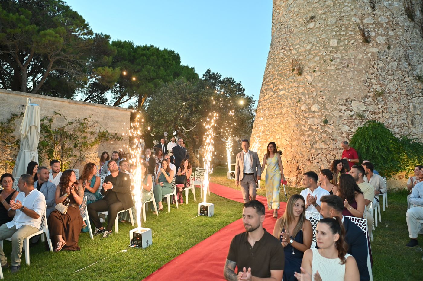 Light fountains in front of the lit Saracen tower