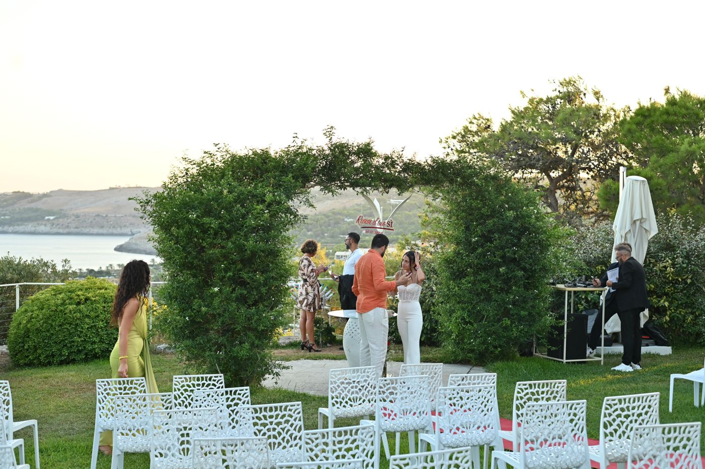 Guests on the terrace looking out to sea at sunset