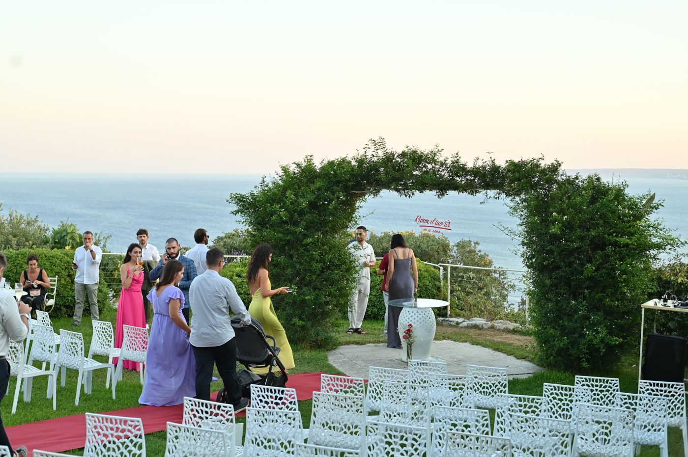 Guests on the terrace looking out to sea at sunset